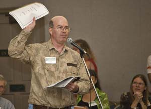 GPUS Political Director Brent McMillan waves his political/ fundraising report while speaking at the annual meeting.