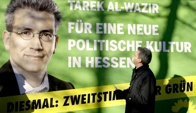 Tarek Al-Wazir, party leader of German green party Buendnis90/Die Gruenen in the German state of Hesse poses in front of an election campaign placard in Wiesbaden December 29, 2008. Al-Wazir will start as green party's top candidate for the upcoming state elections in Hesse, January 18. Slogan on the placard reads 'For a new political culture in Hesse'