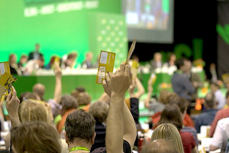 German Greens hold up their vote at the Congress gathering in Berlin. photo by Tobi Specht