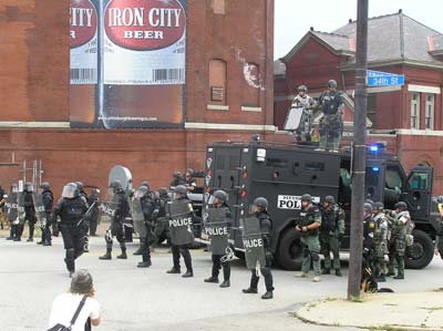 Police block participants at the G20 Summit march on September 24th in Pittsburgh Pennsylvania. They are standing in front of Iron City Brewery, which has moved out of the city. Photo by Mark Child 